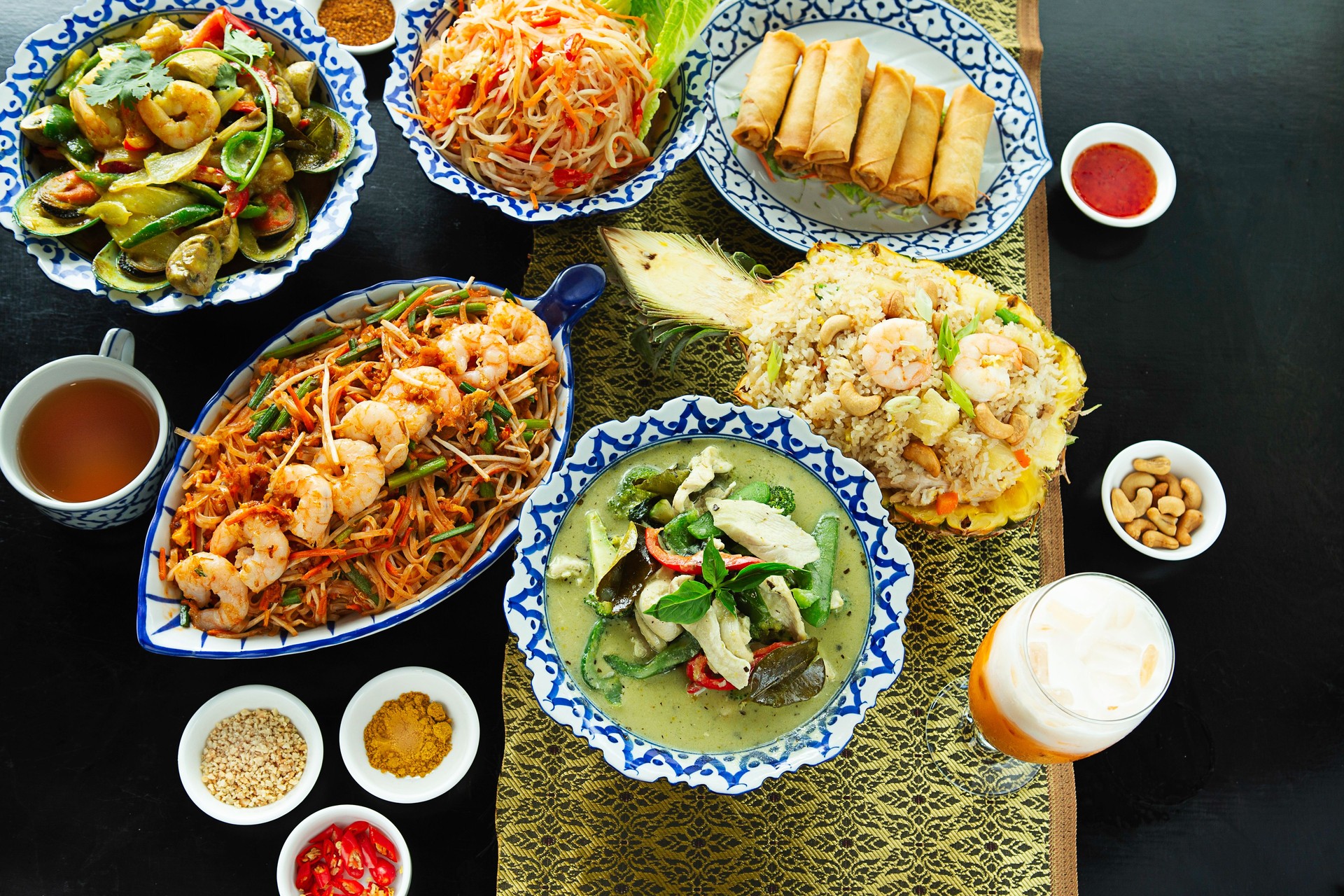 Table full of Thai food dishes